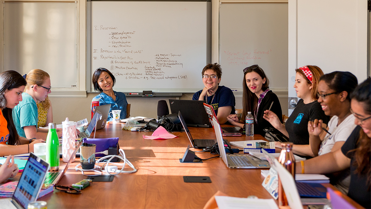teacher and her students around classroom table